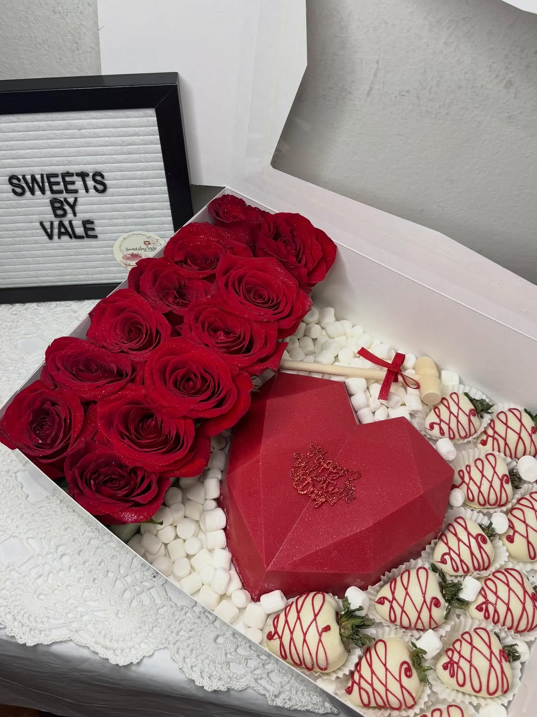 Red roses arrangement with strawberries